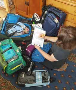 Christine packing and planning her trip